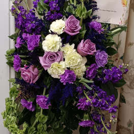 Purple and white floral standing spray with cascading green blooms