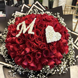 Red rose bouquet with white baby's breath and a white heart accent
