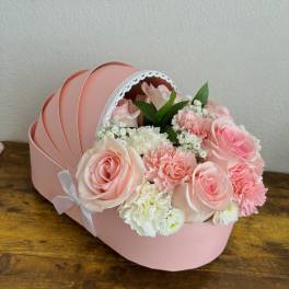 Pink rose and carnation bouquet in a round pink box