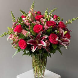 Bouquet of pink roses and lilies in a clear glass vase