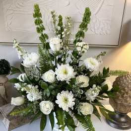 White roses and chrysanthemums in a vase with tall green spikes