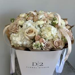 Blush roses and white hydrangeas in a white box with ribbon