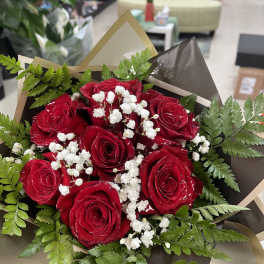 Bouquet of red roses with white baby's breath and greenery