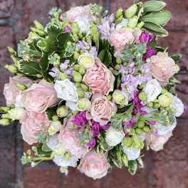 Round bouquet of pink and white roses with lavender flowers