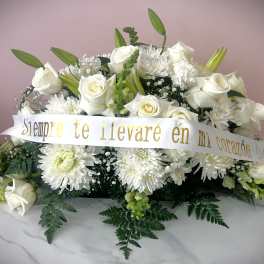 White rose and chrysanthemum arrangement with a memorial ribbon