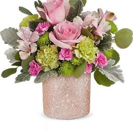 Pink roses and mixed blooms in a glittery pink vase
