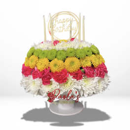 Tiered birthday cake made of colorful flowers with candles and a topper