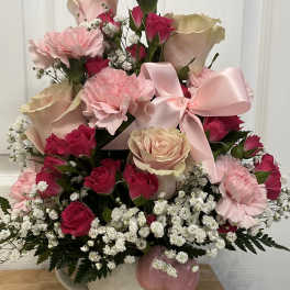 Pink and cream rose bouquet in a Hello Kitty vase with a satin bow