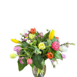 Colorful tulip bouquet in a clear glass vase