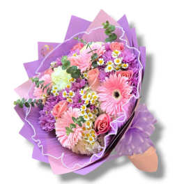 Bouquet of pink and purple flowers wrapped in lavender paper