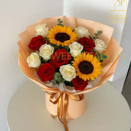 Bouquet of red and white roses with two sunflowers in peach wrapping