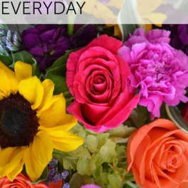 Mixed bouquet with roses, a sunflower, and purple blooms