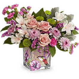 Pink and white mixed flower arrangement in a square glass vase