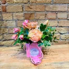 Pink and peach bouquet in a pink gift bag with rope handles