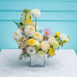 Mixed pastel flower arrangement in a clear glass vase