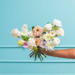 Handheld bouquet of white and pastel flowers