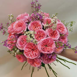 Pink rose bouquet with small purple and white filler flowers