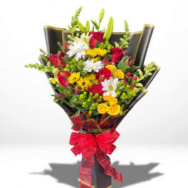 Bouquet of red roses, white daisies, and yellow flowers wrapped in black paper