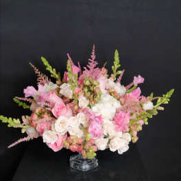 Pink and white rose bouquet in a clear glass vase