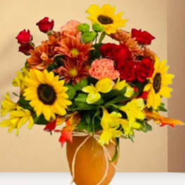 Bouquet of sunflowers, red roses, and orange mums in a vase
