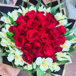 Bouquet of red roses and white alstroemeria with green leaves