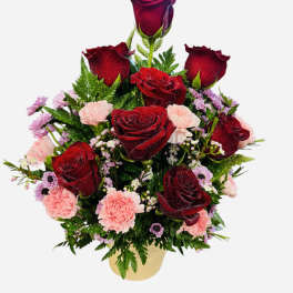 Red roses and pink carnations in a gold vase