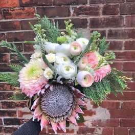 Hand-tied bouquet with pink and white flowers and a large thistle bloom
