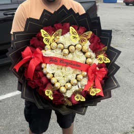 Large bouquet of red and white roses with gold chocolates and butterfly decorations