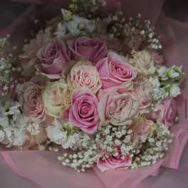 Pink and cream rose bouquet wrapped in pink paper