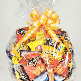 Basket of assorted snack bags wrapped in clear cellophane with a yellow ribbon
