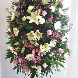Standing floral spray with lilies, pink roses, and white blooms