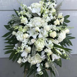Large white floral standing spray on an easel