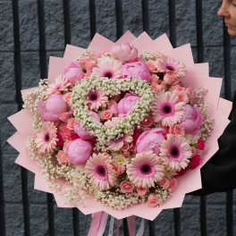 Large pink bouquet with gerbera daisies and roses wrapped in pink paper