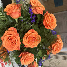 Bouquet of orange roses with purple filler flowers