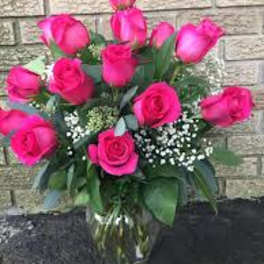 Pink roses arranged in a clear glass vase