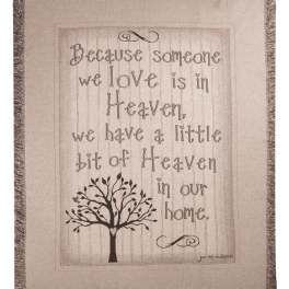 Fringed wall hanging with a quote and tree graphic