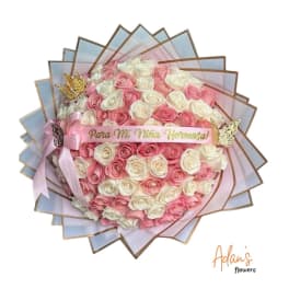 Pink and white rose bouquet with a ribbon and decorative butterflies