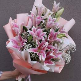 Pink lily bouquet wrapped in pastel paper