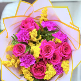 Bouquet of hot pink roses and carnations with yellow filler flowers
