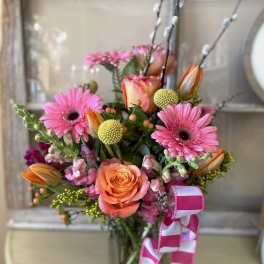Pink and peach mixed flower bouquet with a striped ribbon