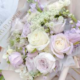 Bouquet of pale lavender and white roses with airy filler flowers