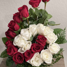 Bouquet of red and white roses with greenery