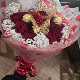 Bouquet of red roses with white baby's breath and gold decorations