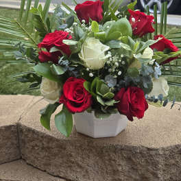 Bouquet of red and white roses in a white vase