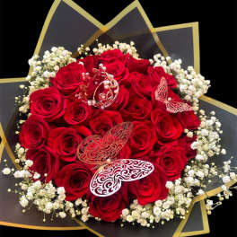 Bouquet of red roses with white baby's breath and butterfly decorations