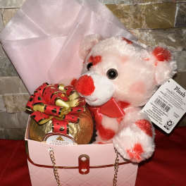 Gift box with a teddy bear and wrapped chocolate gift