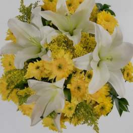 Bouquet of white lilies mixed with yellow daisies and small yellow filler flowers