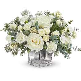 White roses and carnations in a clear square vase