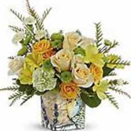 Bouquet of yellow and white flowers in a patterned vase