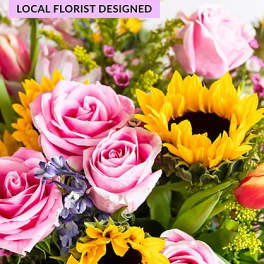 Pink roses and yellow sunflowers in a mixed bouquet
